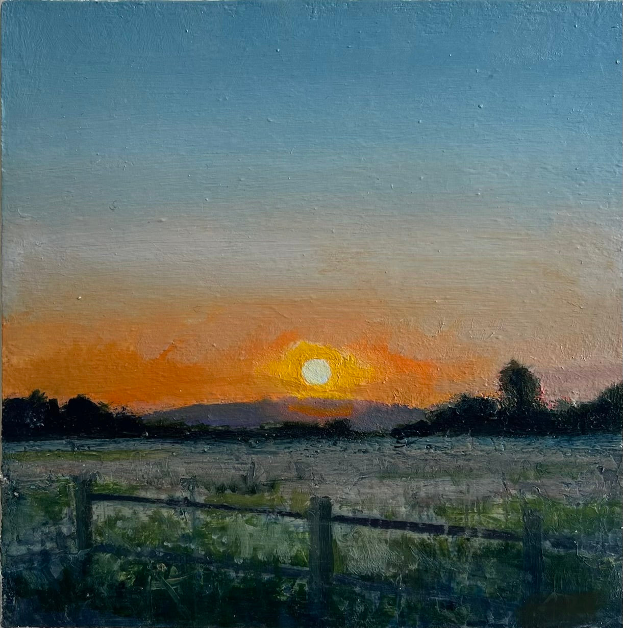 Fenced in field at sundown