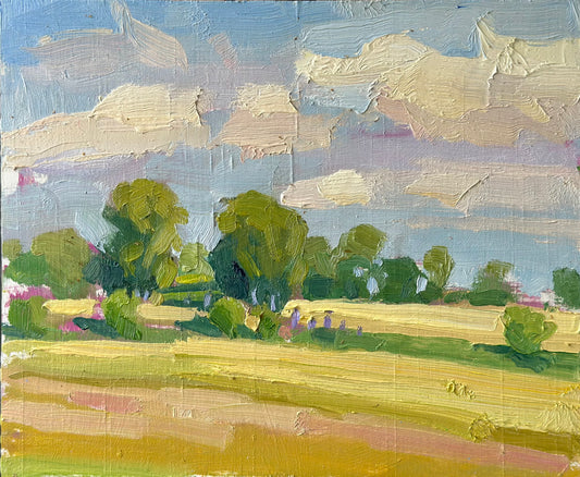 An impressionistic landscape oil painting featuring a golden field in the foreground, a line of green trees, and a blue sky filled with textured cream and lavender clouds.